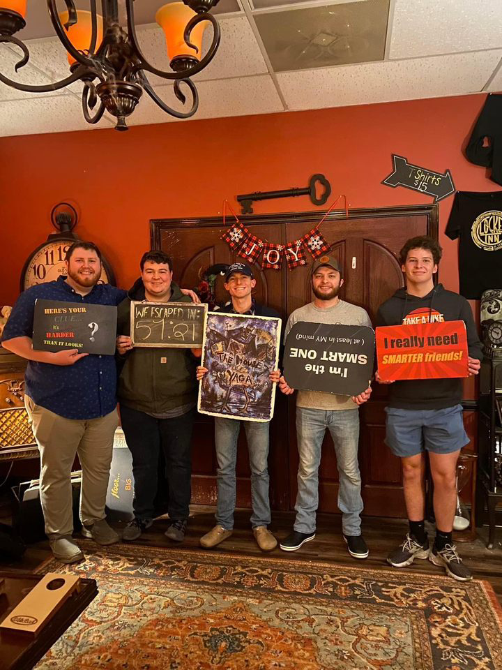 5 guys pose after an escape room